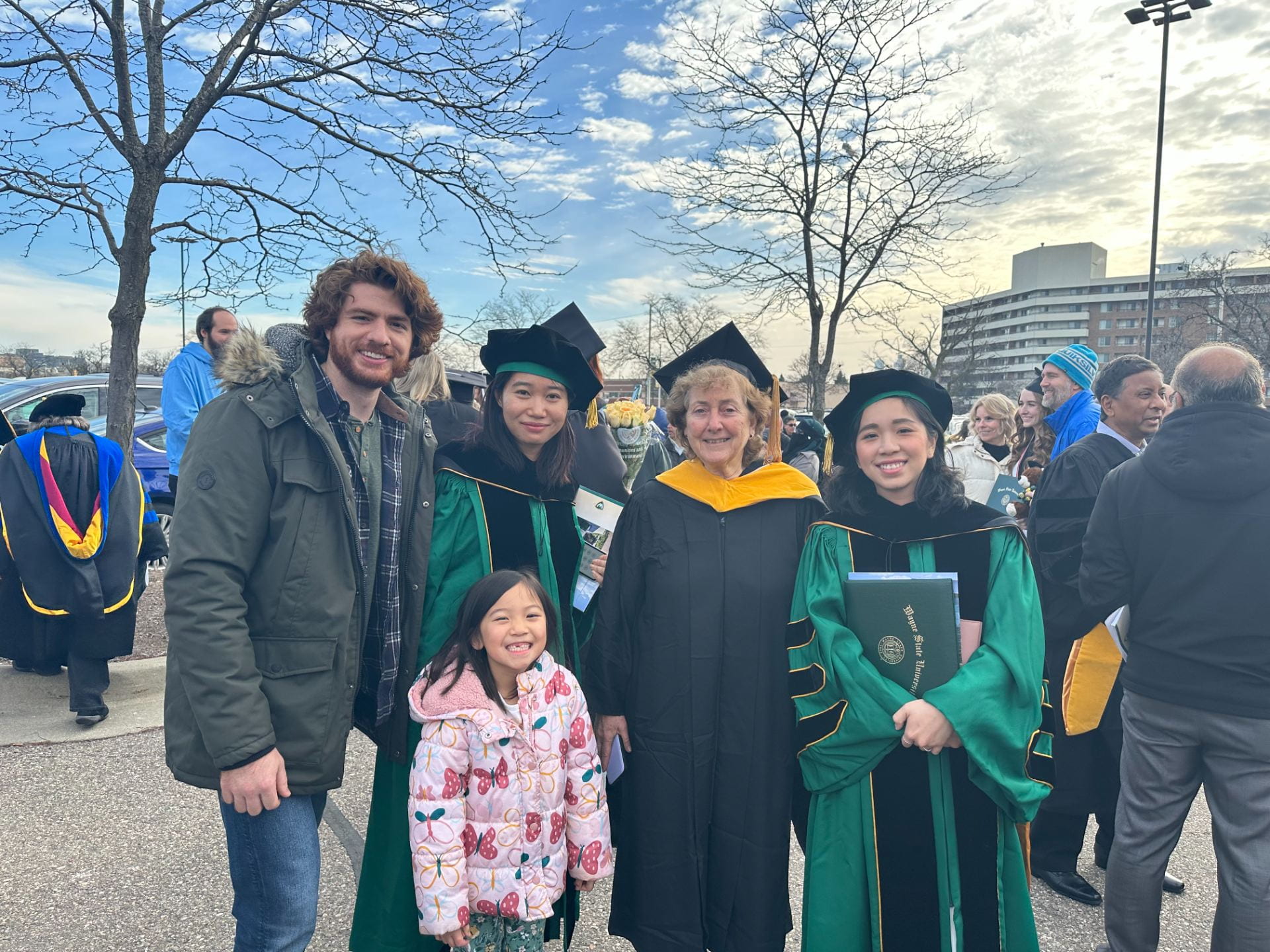 12/16/2023: Dr. Zhuqing Liang and Dr. Linh Vo walk across the stage at WSU commencement ceremony alongside other WSU Biological Sciences graduates