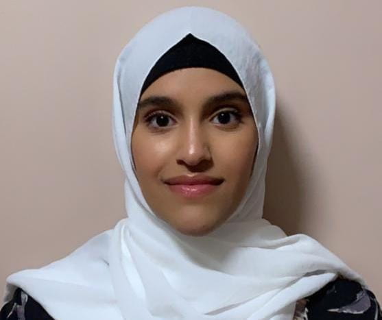 Headshot of Saba Dubaishi. She is wearing a white hijab with a black hair cover underneath.