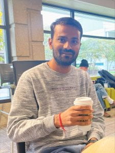 Picture of kartikey holding a cup of coffee 